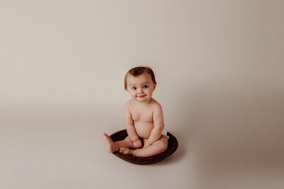  Baby Bristol sitting in a small wooden bowl against a neutral beige background.