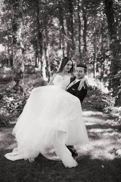 Black and white image of wedding couple in forest