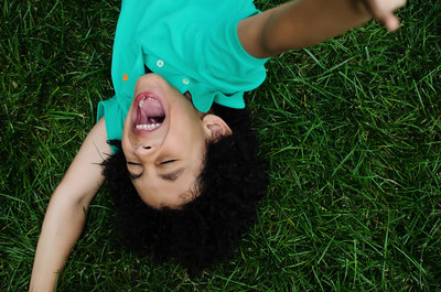 Lifestyle portrait of happy kid playing in grass