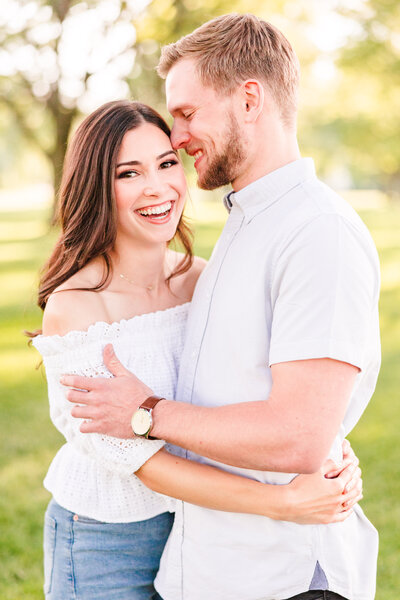 Couple laugh together during their engagement session in Austin, Texas. Photo taken by Austin Engagement Photographers, Joanna & Brett Photography