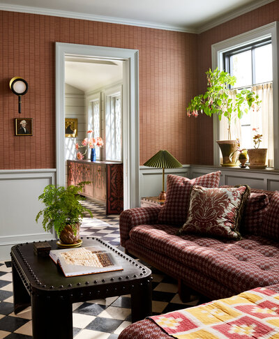 Livingroom with natural light and peek through a doorway at the dining buffet. 