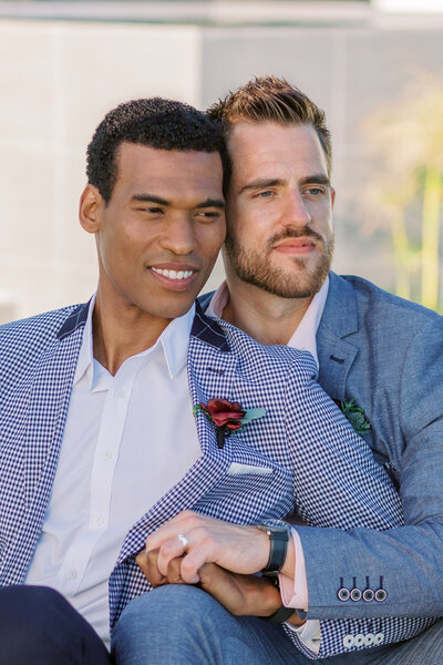 Same sex couple looking  away