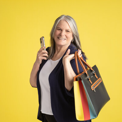 Image of a  professional looking woman smiling and talking on the phone