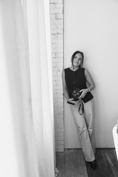 Alexandra Eveland in artistic black and white suit looking towards the camera