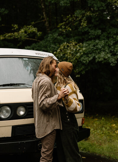 Couple hold hands and share a kiss during their oregon engagement session.