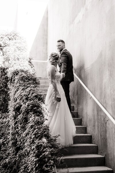 Bride and groom walking past each other on stairs at Mountain Shadows.