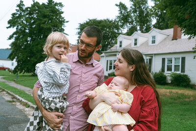 couple holding baby and toddler during family photos by Elsie Goodman Photography