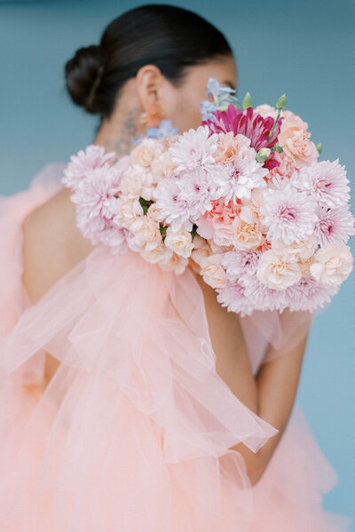 woman wearing pink tulle gown holding pink bouquet