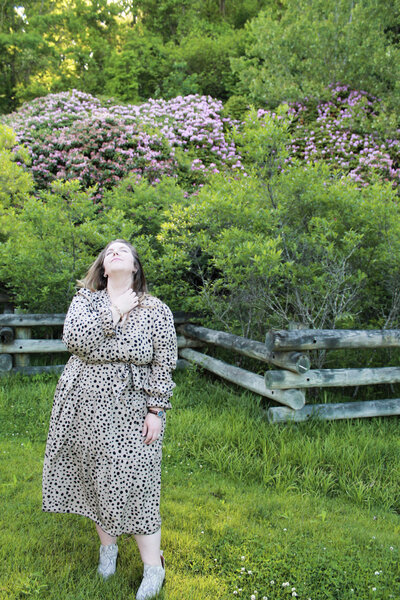 Ashleigh Henry, coach and founder, photographed in Asheville in black and brown dress — guiding women through the quiet unraveling of post-success life.