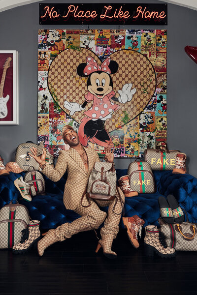 Stylish portrait of Todrick Hall in Gucci, with a vibrant floral backdrop enhancing the scene, shot by Ylva Erevall.