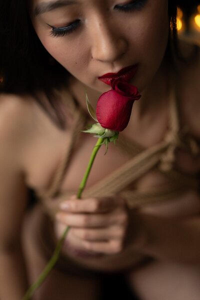 Woman posing with shibari chest harness in a sexy boudoir shoot with Magan Rogers in Ferndale Michigan.