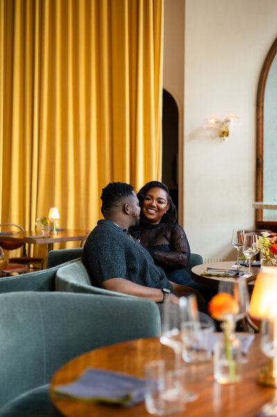 A couple sits and laughs at Le Bon Nosh in Atlanta, GA.