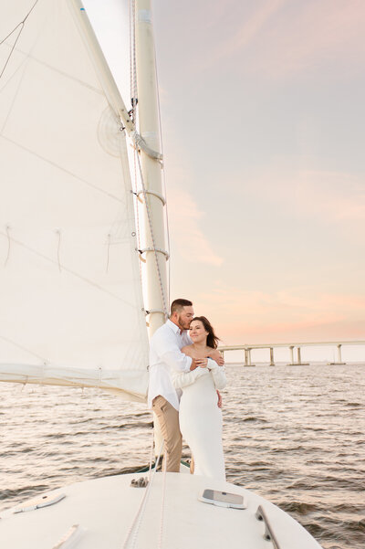 Orlando couples photographer captures stunning image of couple on a sailboat at sunset