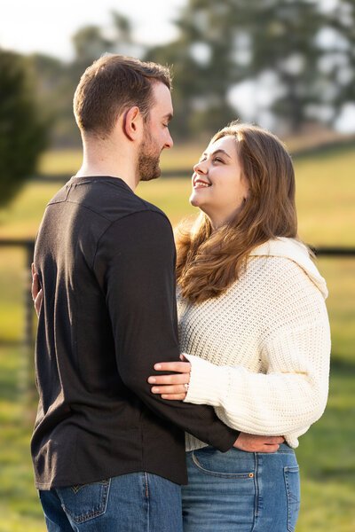 couple holding each other and smiling at the Virginia State Arboretum