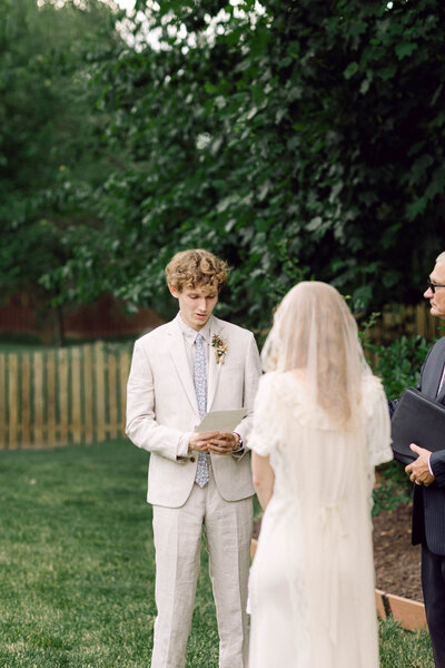 Peyton Curry and Jon exchanging vows during their backyard wedding ceremony in Richmond.
