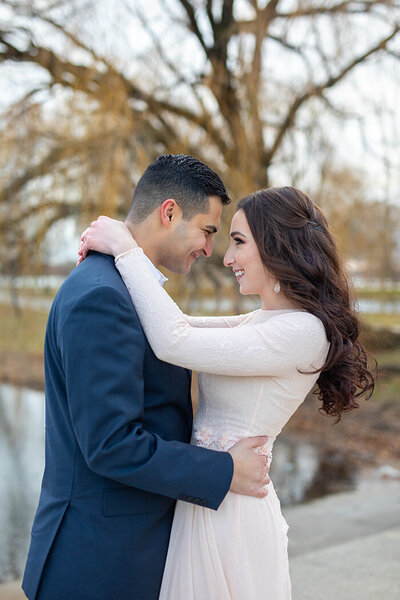 Couple smiling at each other in park