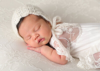 Newborn baby girl in bonnet