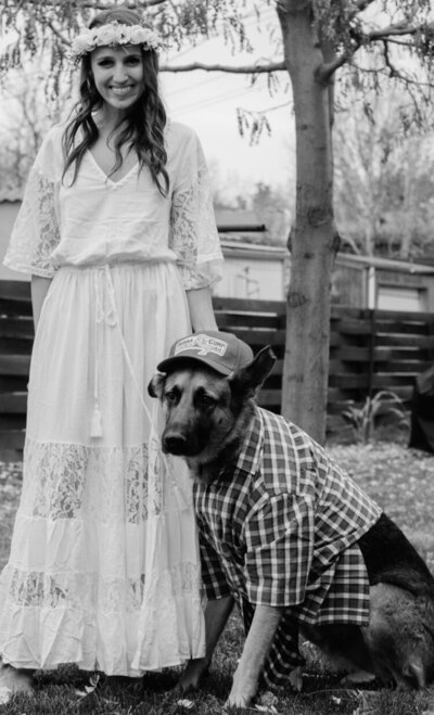 Girl dressed up next to German Shepherd in costume