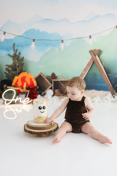 Boy in birthday outfit eating an Elmo cake during themed cake smash session— captured by Alliston and Barrie cake smash photographer.