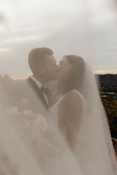 Arizona Bride and groom kiss behind the veil