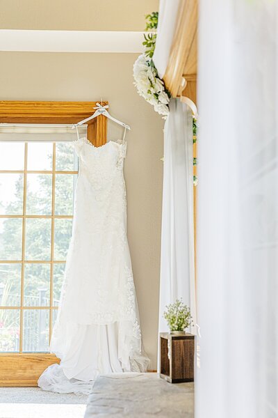 Wedding dress hanging from window frame