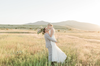 Bride and groom sharing a joyful moment together on their wedding day in Columbus, Ohio, captured in a beautiful outdoor setting.