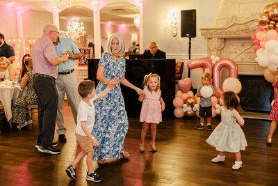 A grandmother dances with her grandkids at her birthday party in Union County, NJ.
