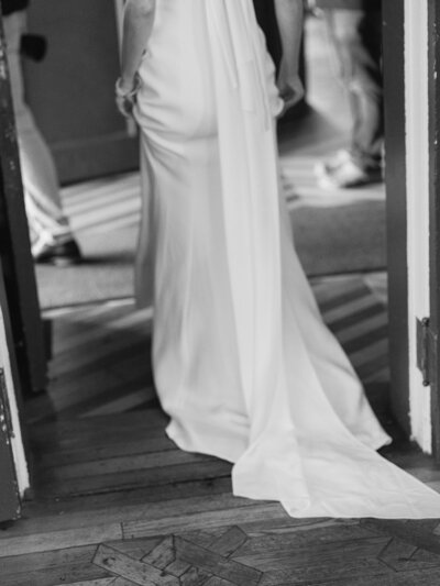 Black and white photography of brides wedding dress train