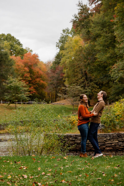 photograph of a couple laughing during their engagement photo shoot.