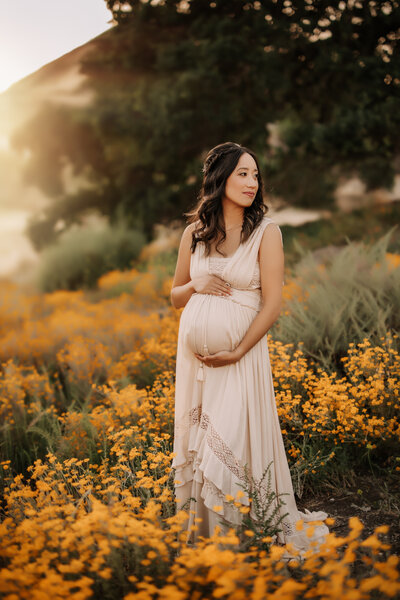 Maternity Photographer, expecting mother in the flowers in the hills