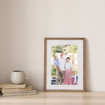 mockup photo of a framed portrait of a family of four taken by an Austin Family Photographer.