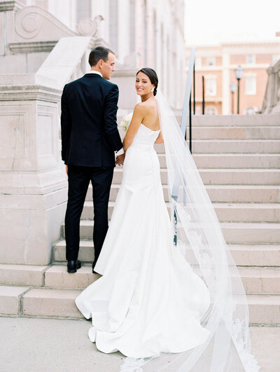 Bride and groom walk up memorial steps at their DC wedding