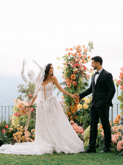 Husband and wife at the altar, surrounded by florals in every direction.