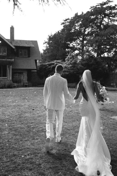 Back of a wedding couple holding hands