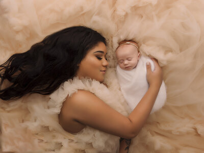 baby and mother laying down sleeping for photo at seattle studio near seattle