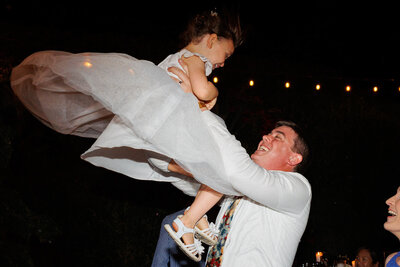 flower girl tossed in the air during dancing
