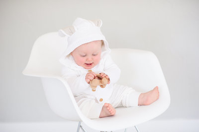 Little girl missing two front teeth sitting in chair at boise photography studio during child photos with Tiffany Hix