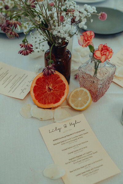 A wedding table set up with menu and flowers
