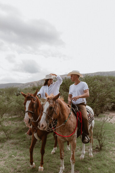 couple riding horseback together