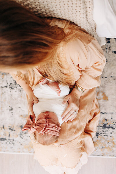 dad kissing his newborn baby girl during a newborn photography session