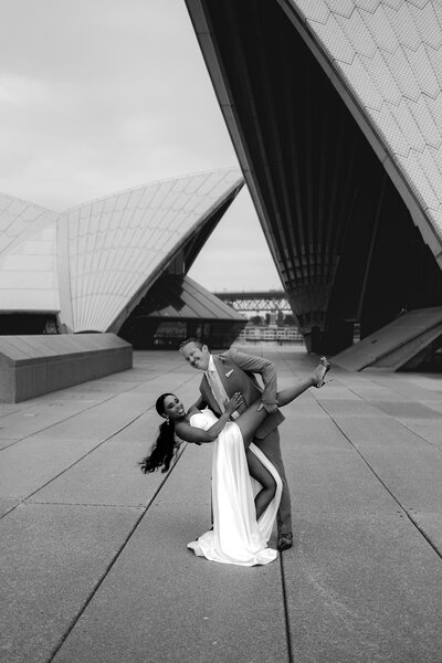 Man in a suit dips his wife in a white gown in Australia