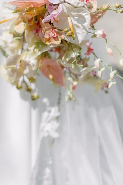 Beautiful bride looks down at her wedding bouquet
