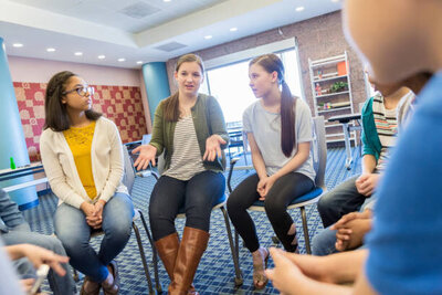 Group of girls sitting in circle and talking