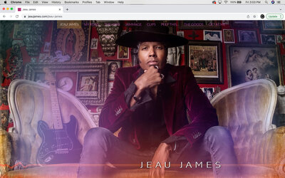 Musician branding website home page design example Jeau James sitting on gold antique sofa black guitar beside him resting chin on hand wearing wide brim hat burgundy blazer jeans religious photos on wall behind him Package A