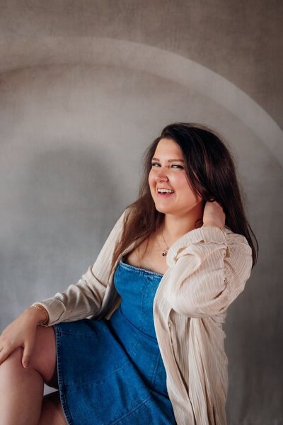 Kemotion brand designer smiling in headshot, focused on website design tips for service-based businesses.