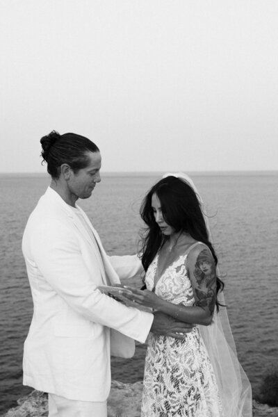 A bride is reading her vows to her future husband