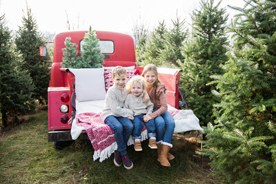 family with dog at tree farm golden retriever
