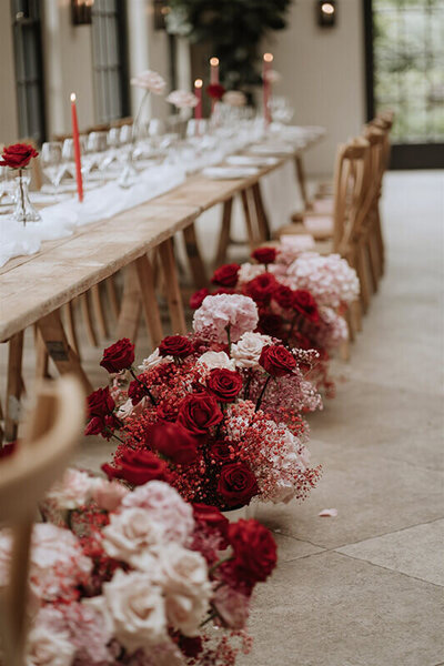 Red, pink and white wedding flowers decorating the venue