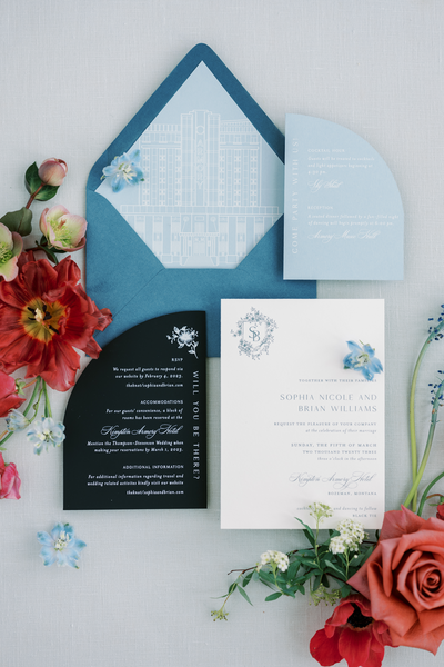A sophisticated wedding suite featuring a striking contrast of black and light blue hues with classic typography, showcasing elegant invitation ideas that combine modern design with timeless charm.