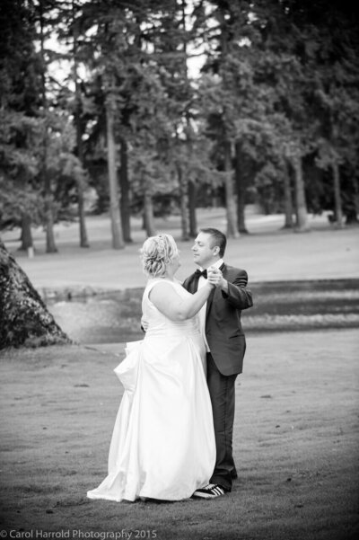 Bride and groom share a dance on the lawn